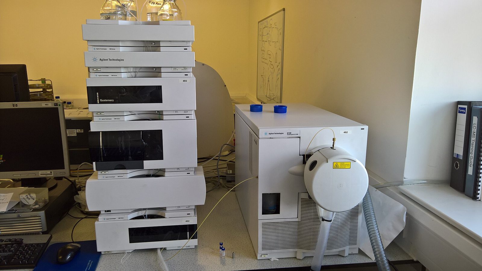 A liquid chromatography stack connected to a quadrupole mass spectrometer on a laboratory bench.